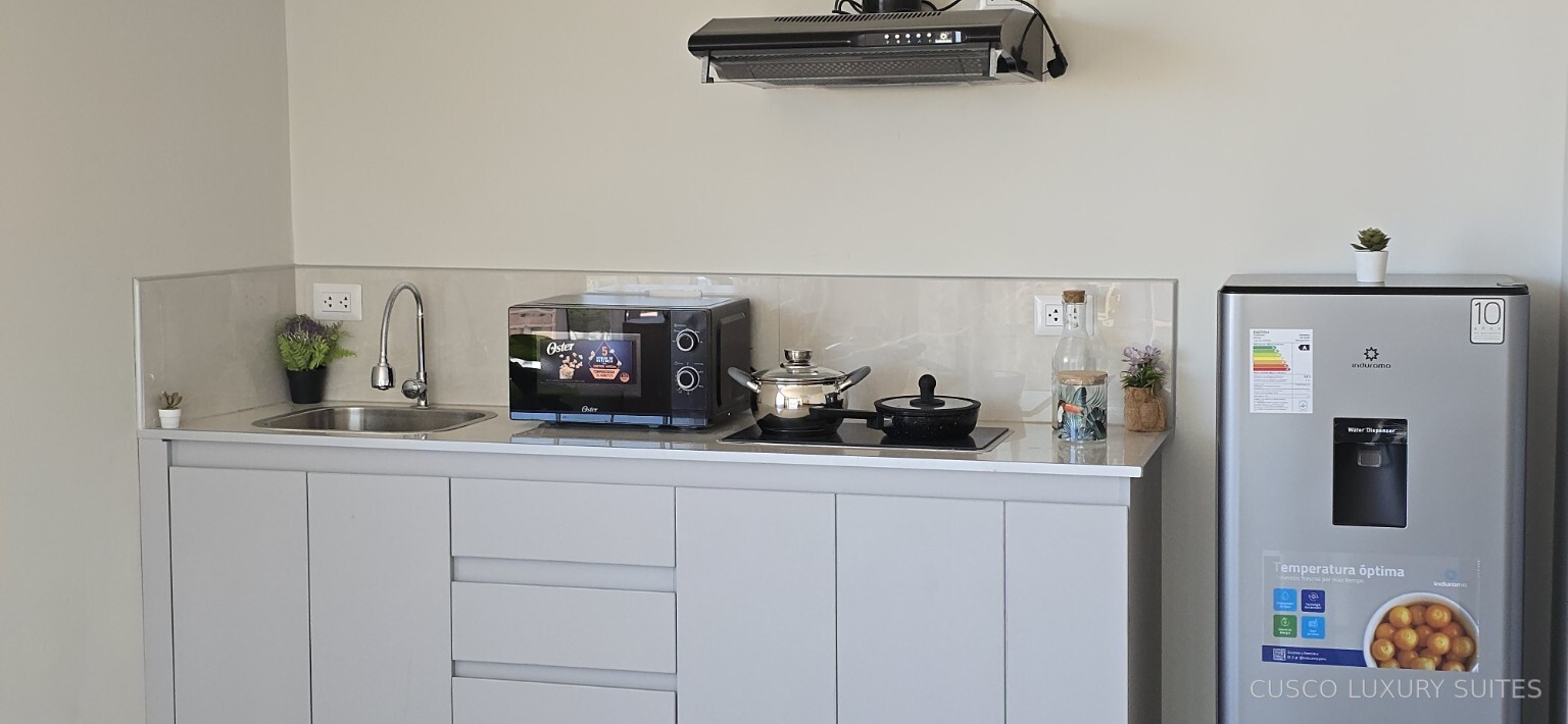 Complete SUMAQ SUITE kitchen with microwave, cooktop and refrigerator