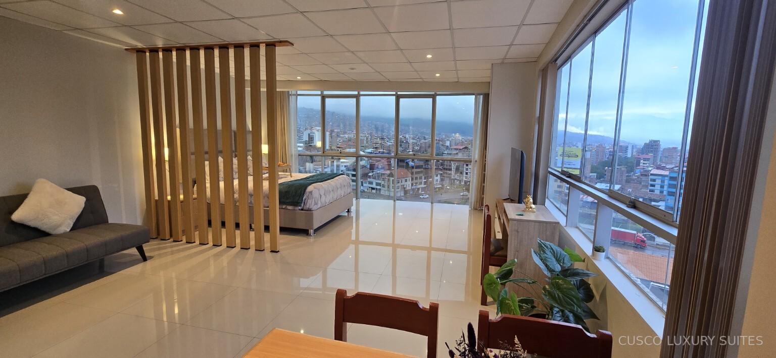 SUMAQ SUITE living and dining space with city views on two sides
